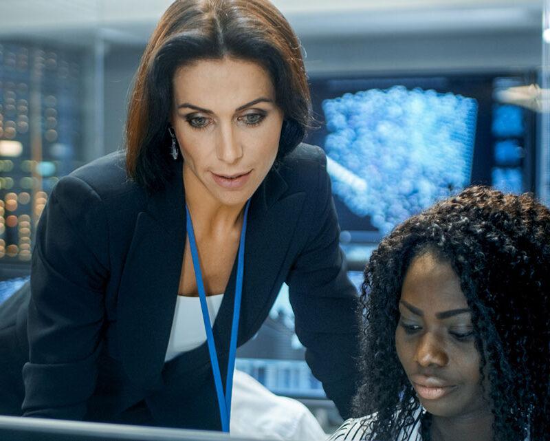 S3 Security engineers work together in server room.