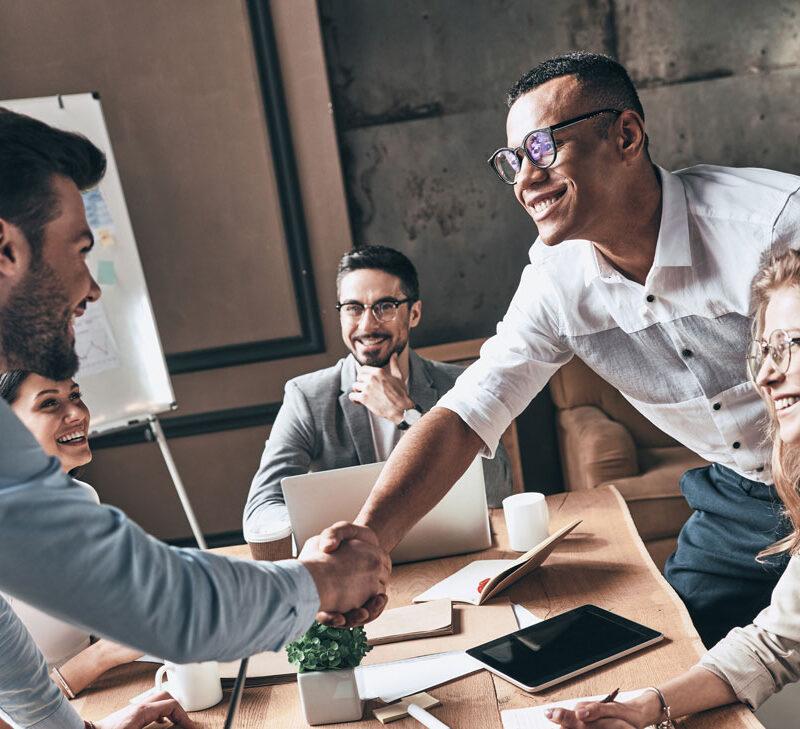 S3 Security engineers shaking hands in the office.